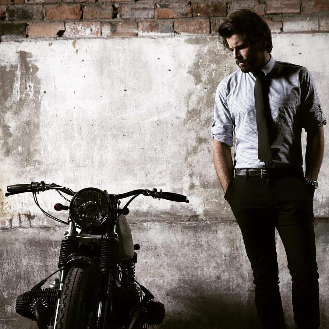 man staring at a classic motorcycle