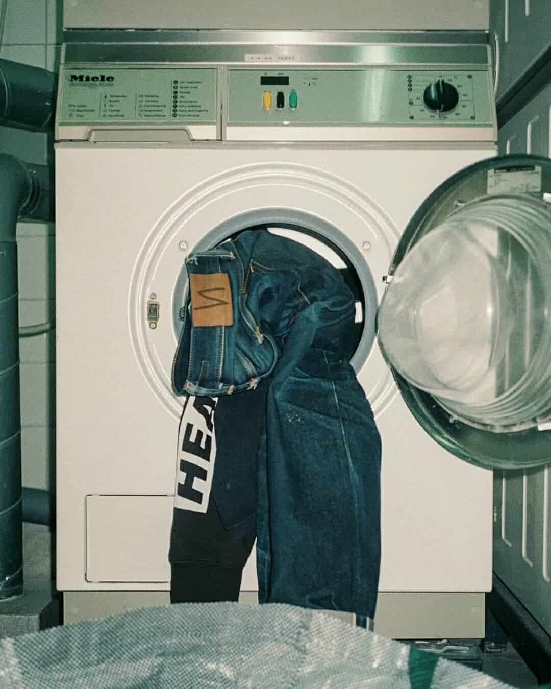loading clothes into a washing machine