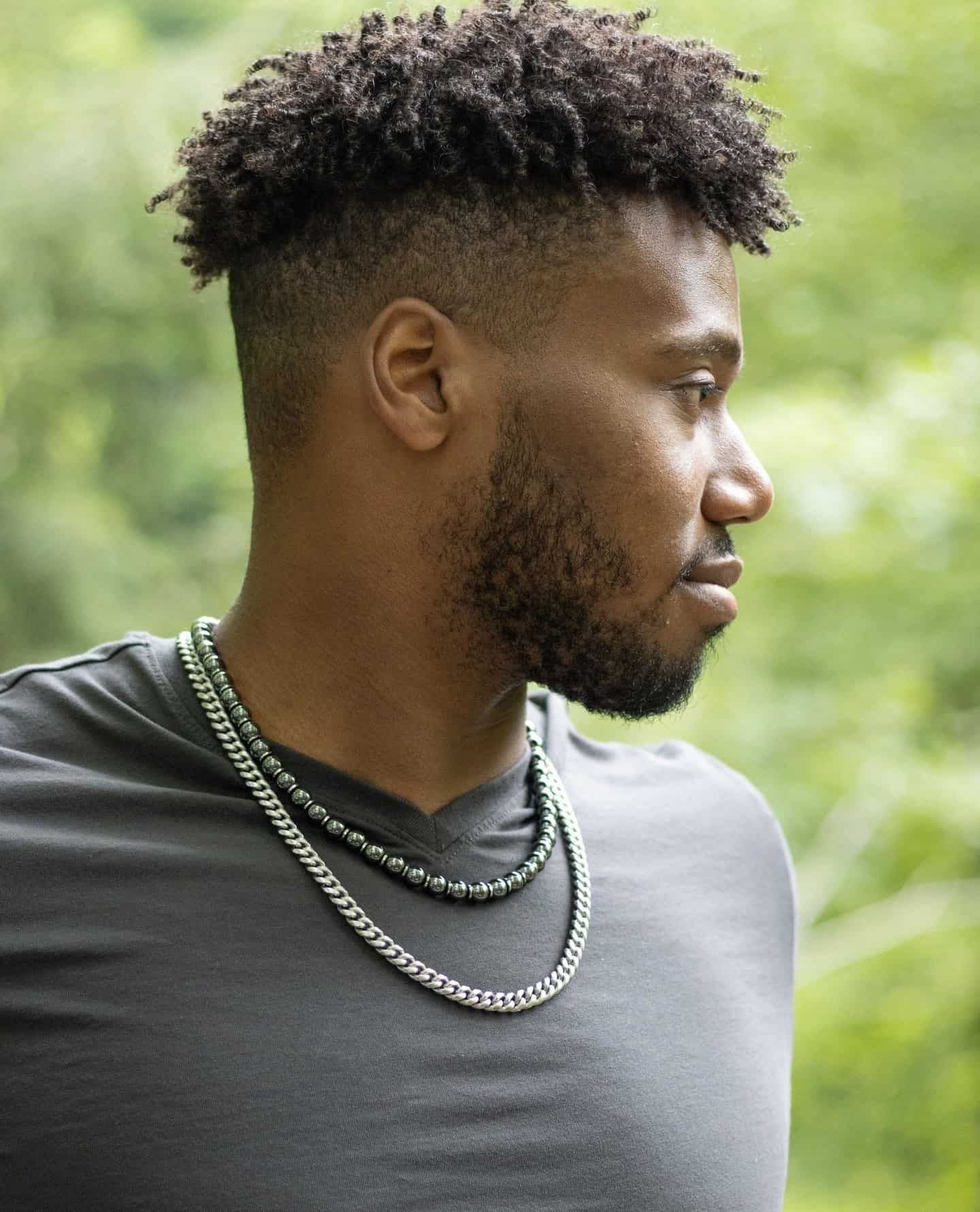 man wearing a bead and chain necklaces