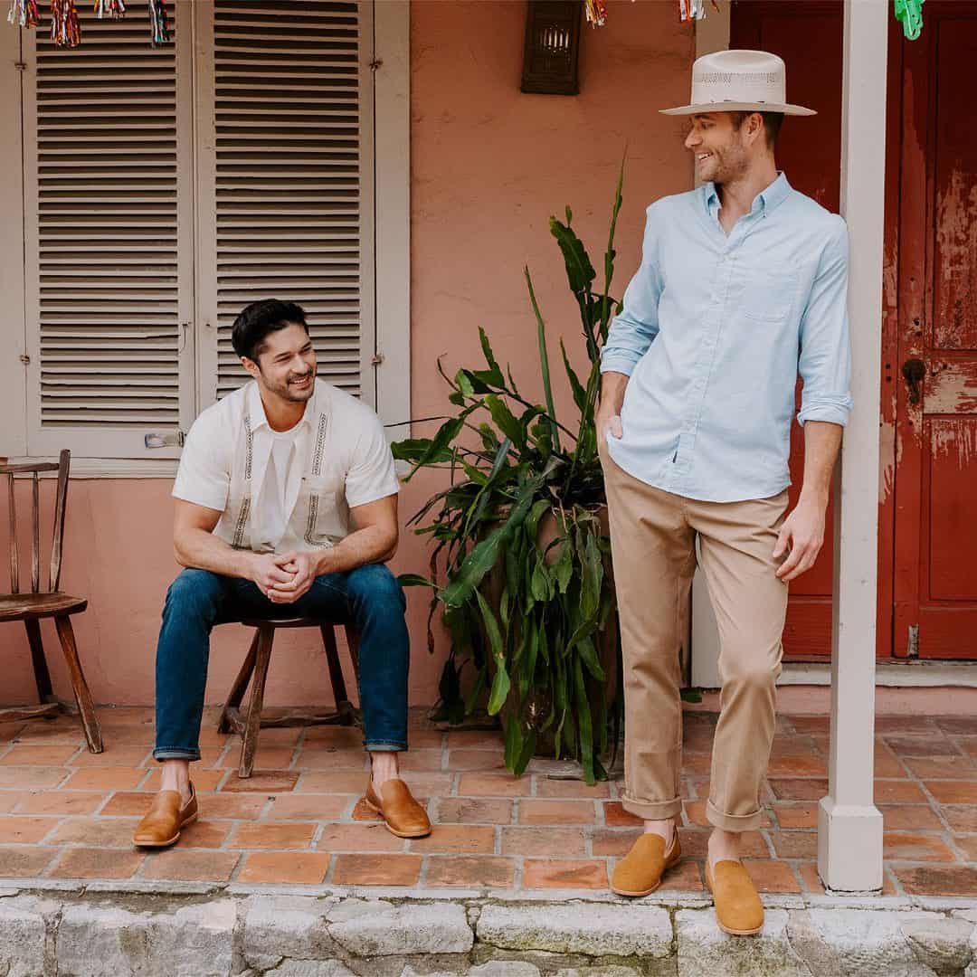 two men on the porch wearing slip-ons by tecovas