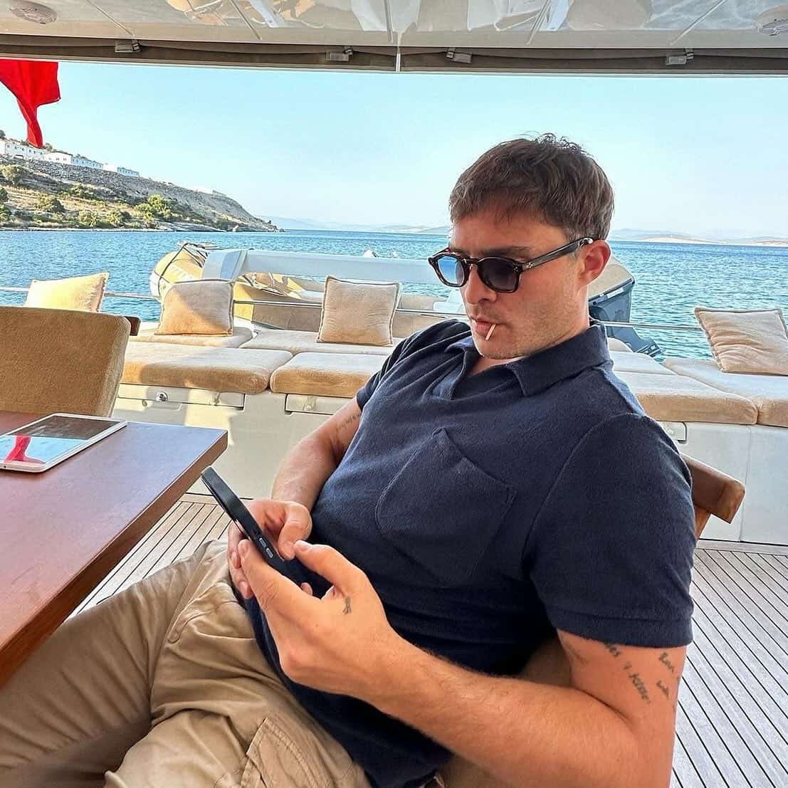 man checking his phone in a yatch