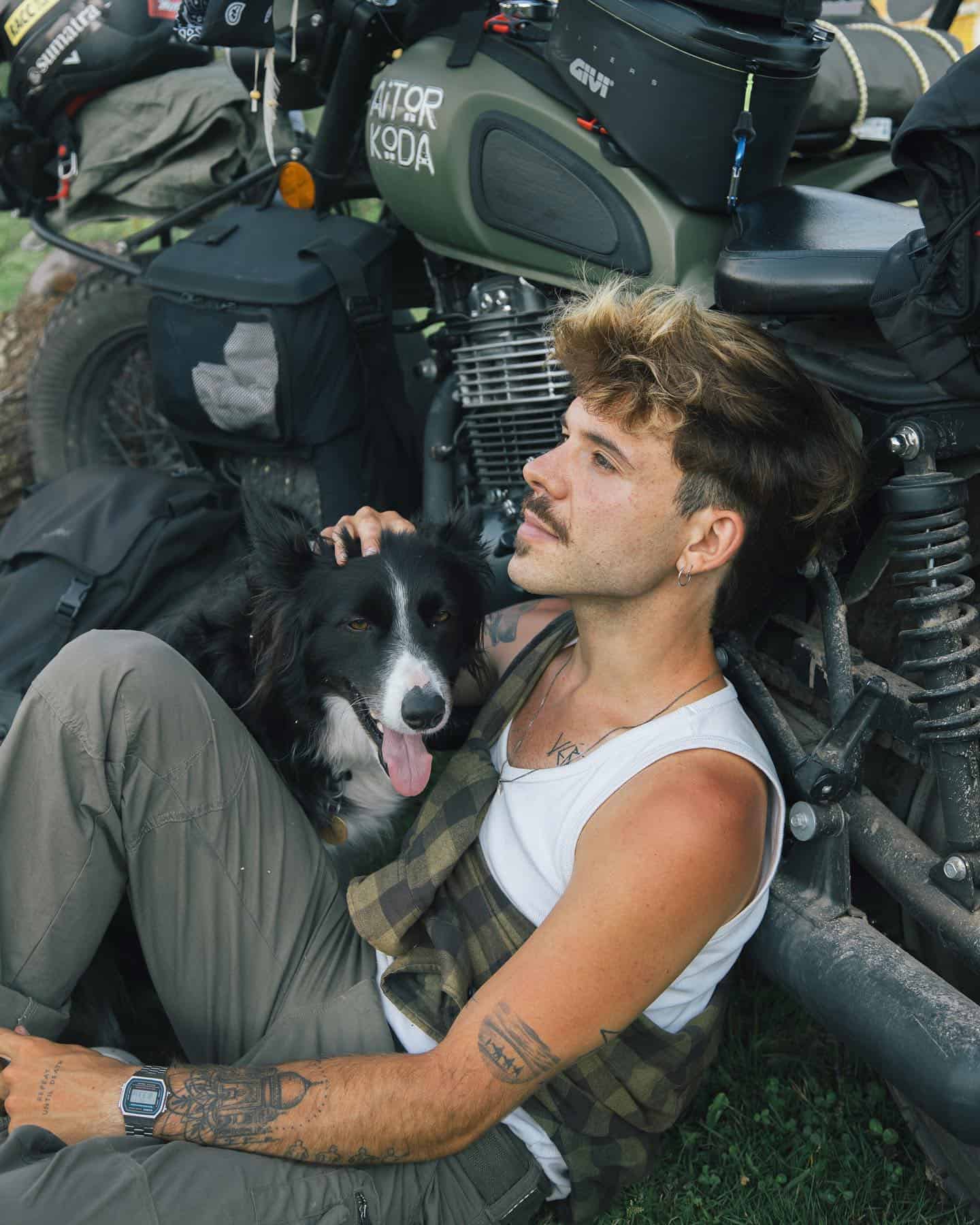 man with dog taking a rest from a motorcycle trip