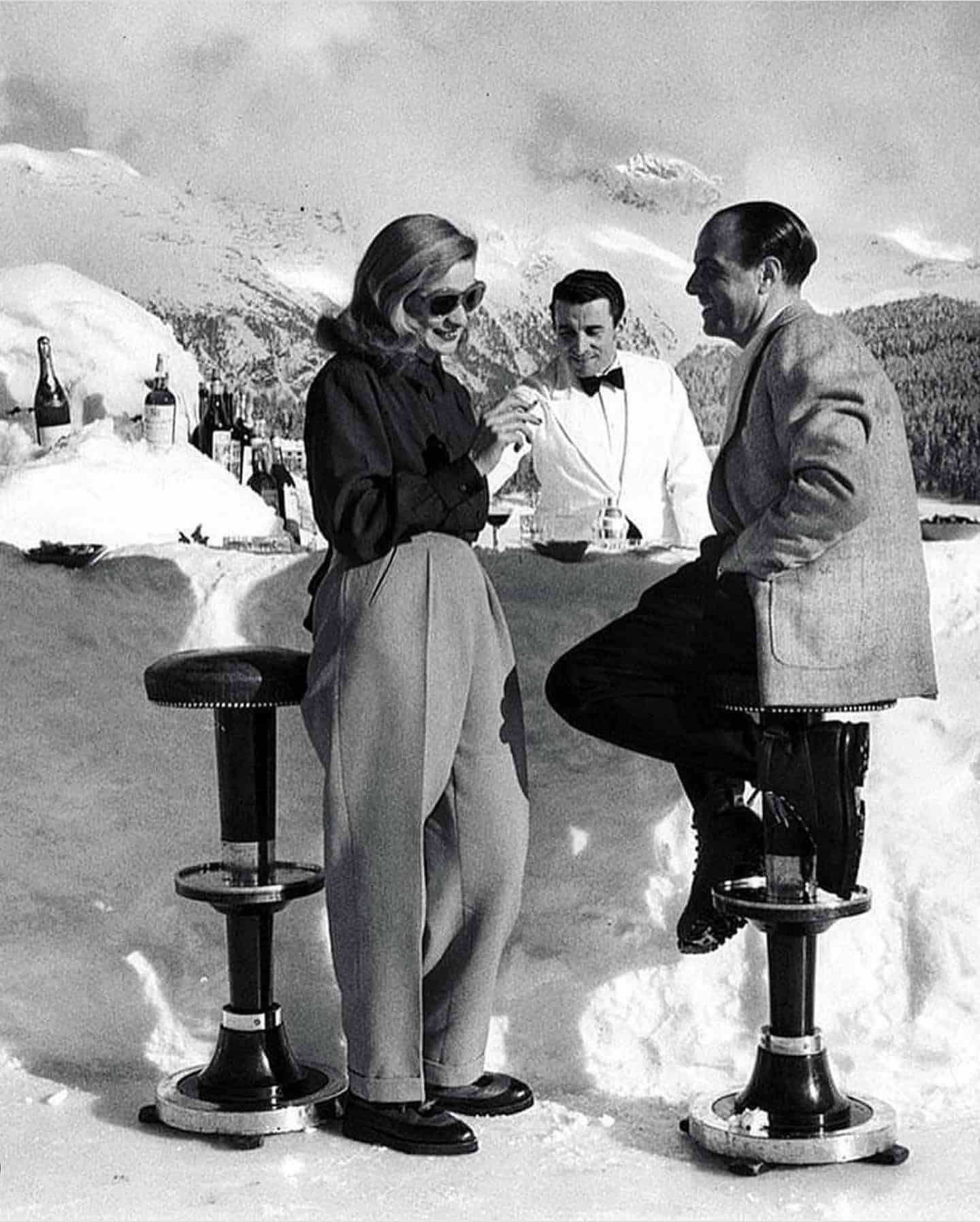 couples having a drink from a bar made out of snow