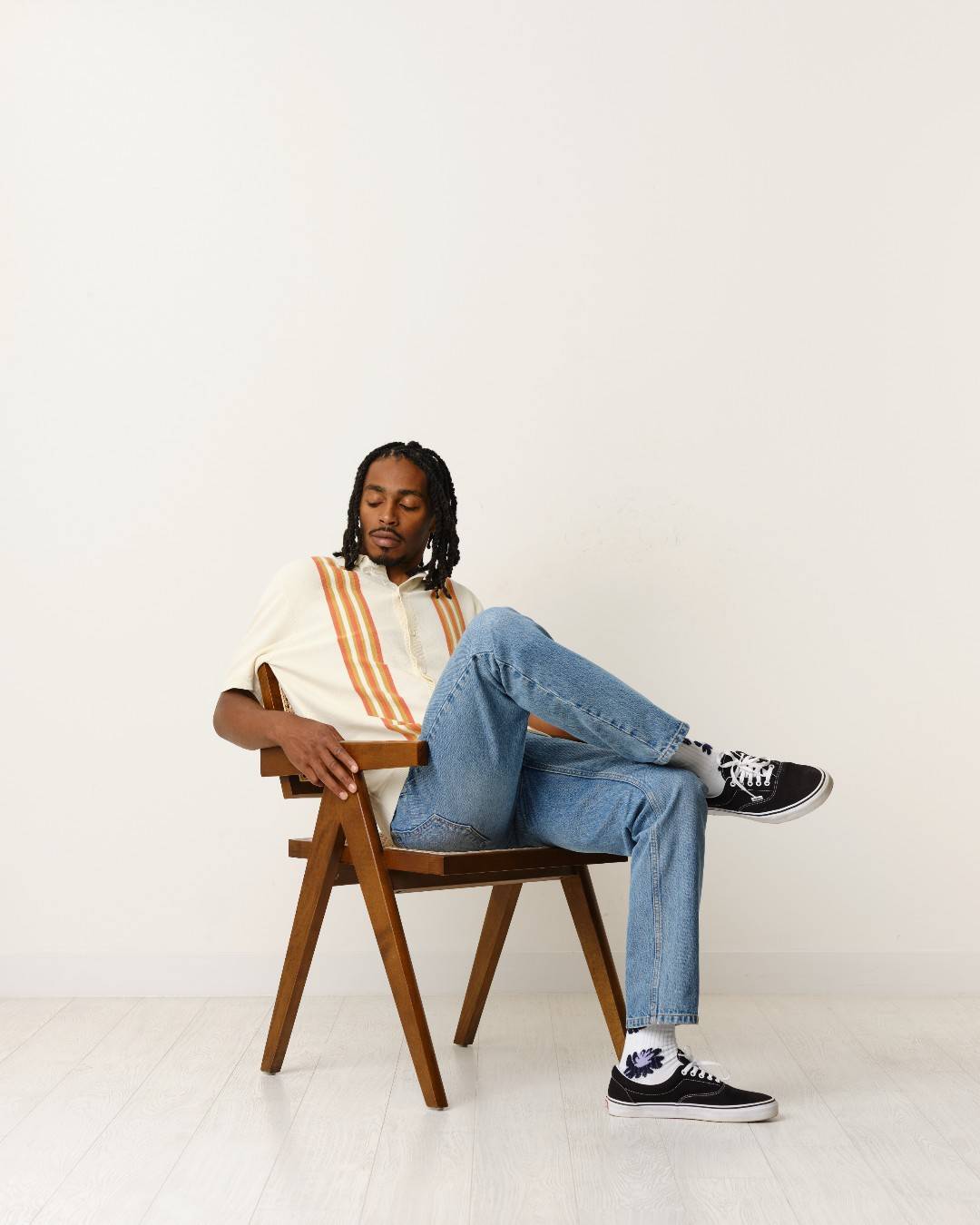 man sitting comfortably on a wooden chair