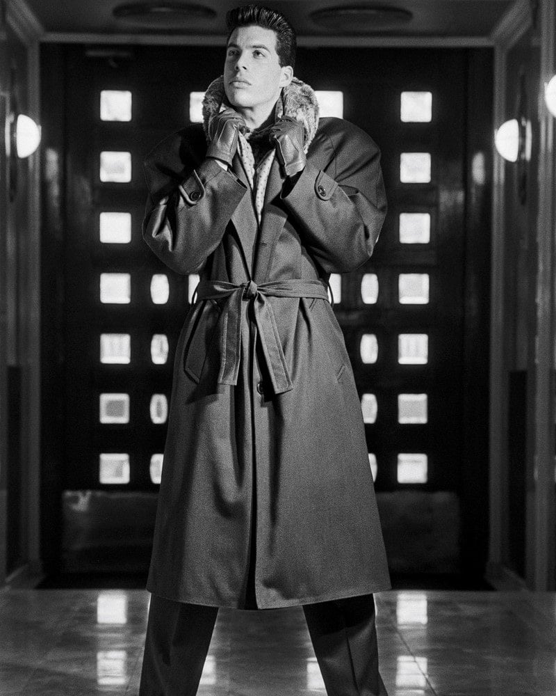 man wearing a long coat with fur collar