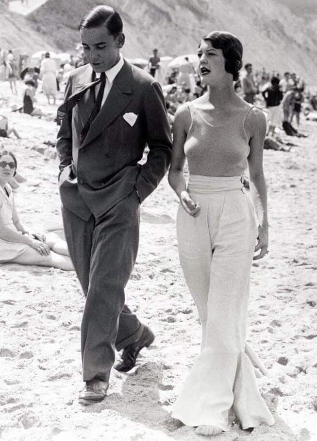 couple in 1930s walking at the beach