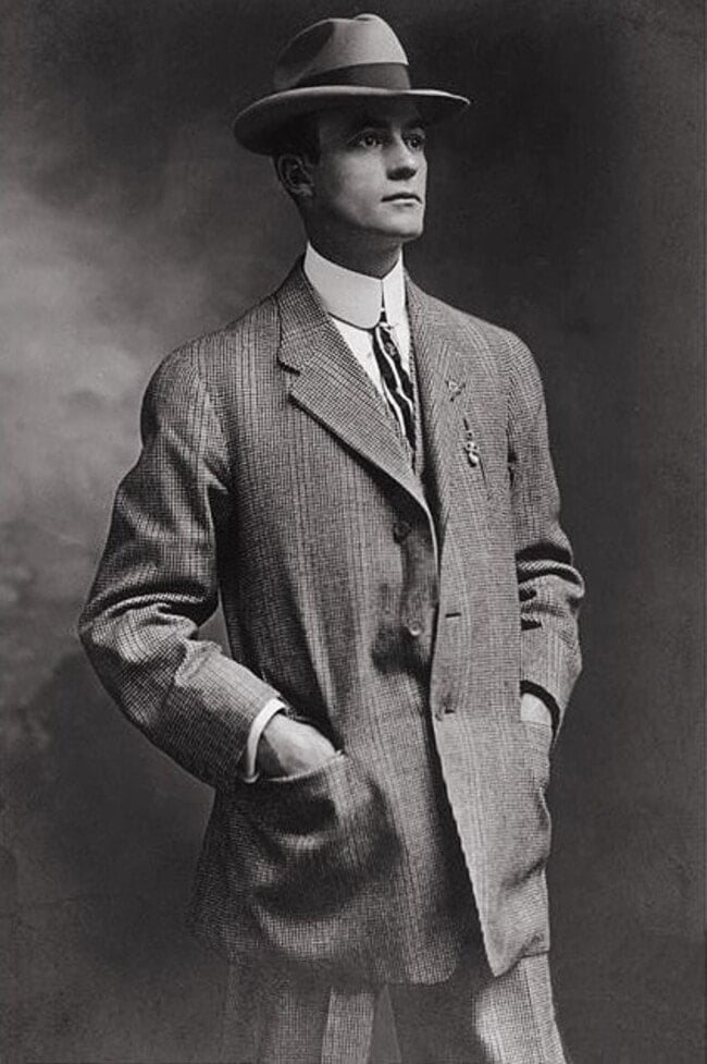 man in 1930s wearing a 3 piece suit and a hat