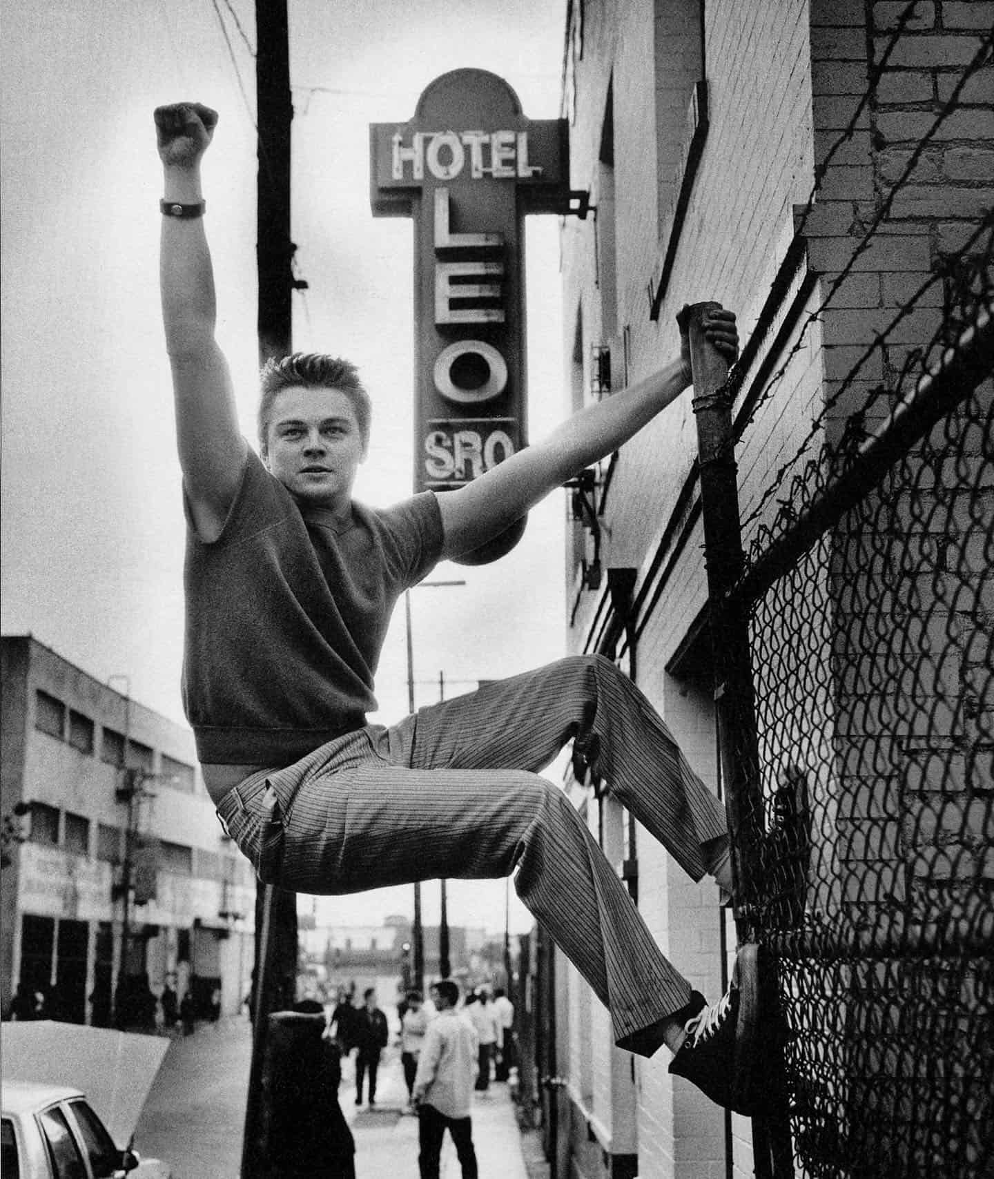 Leonardo Di Caprio climbing a fence 1999