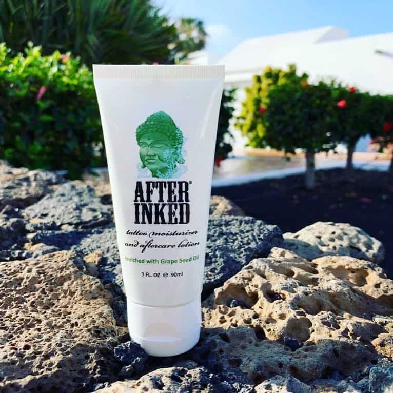 a tube of after inked tattoo after care lotion on top of rocks