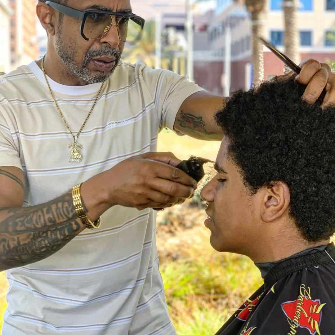 barber trimming brows with andis GTX EXE
