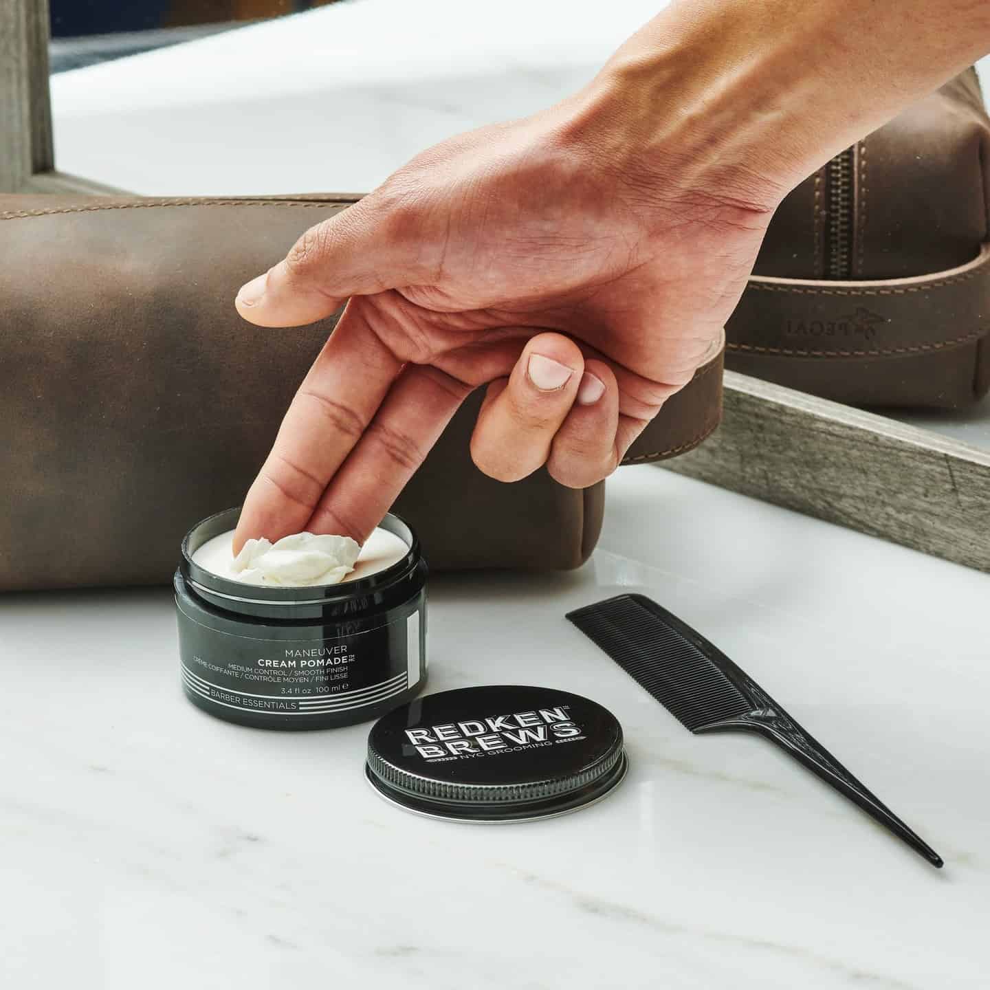 scooping a redken brews cream pomade