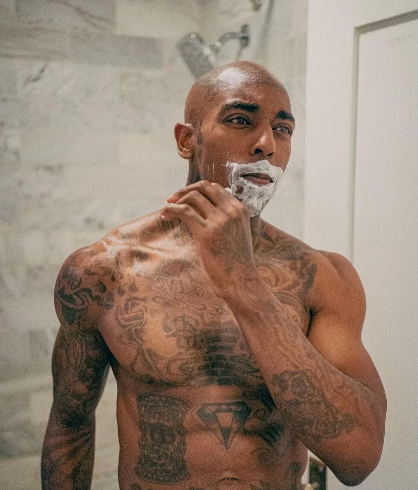 man shaving beard with the bevel safety razor