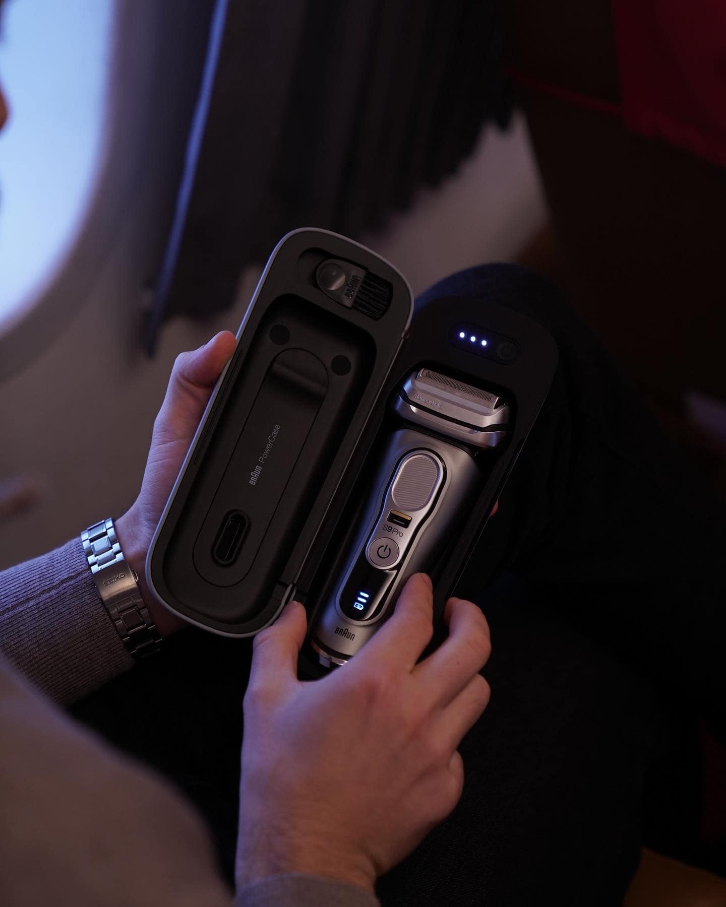 man holding a braun series 9 foil razor with charging case