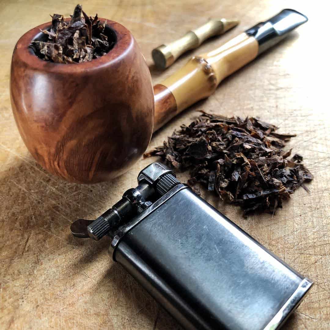 a tobacco filled pipe and a lighter