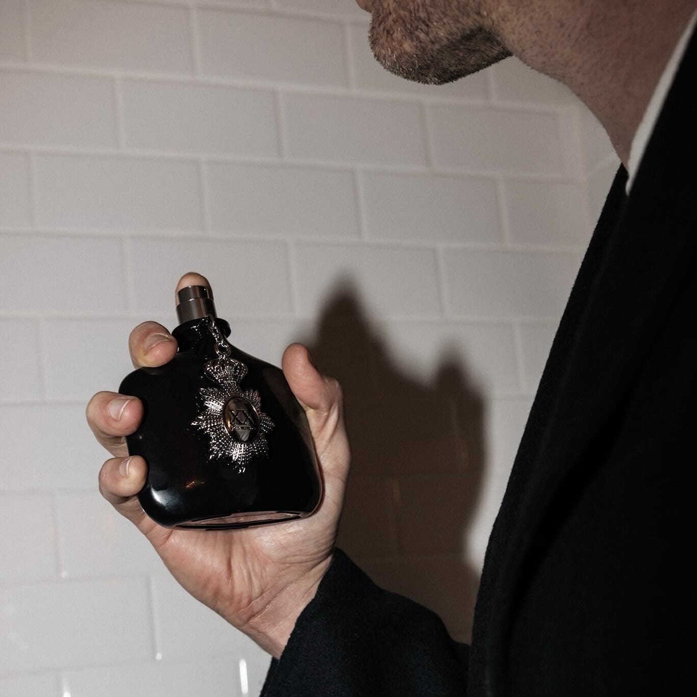 man spraying a XX cologne by john varvatos