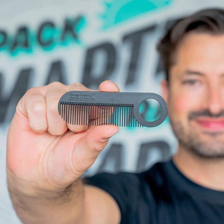 man holding a pocket comb by chicago comb