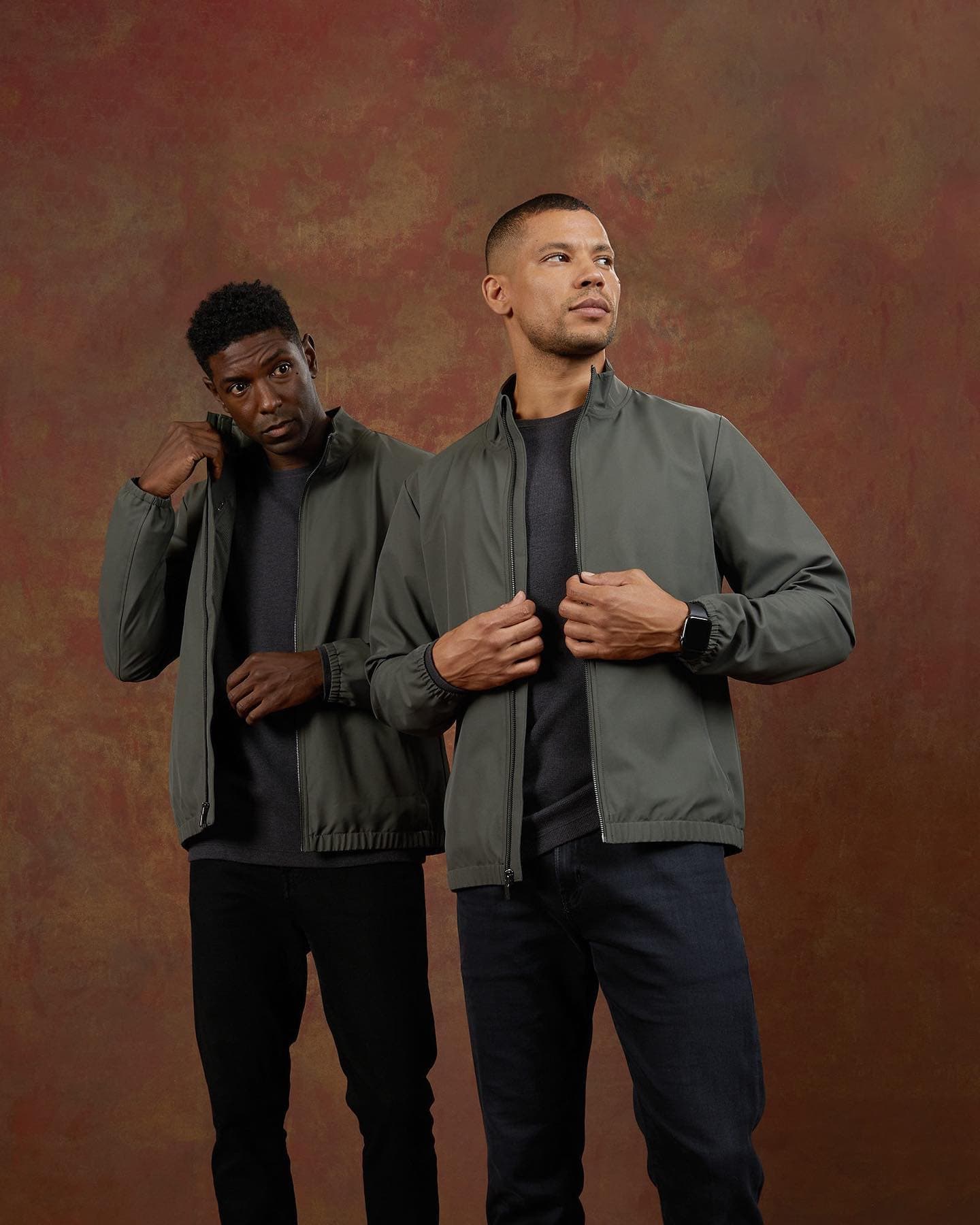 two men wearing a grey bomber jacket