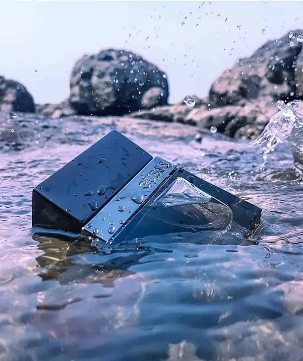 a bottle of guess seductive cologne in the water