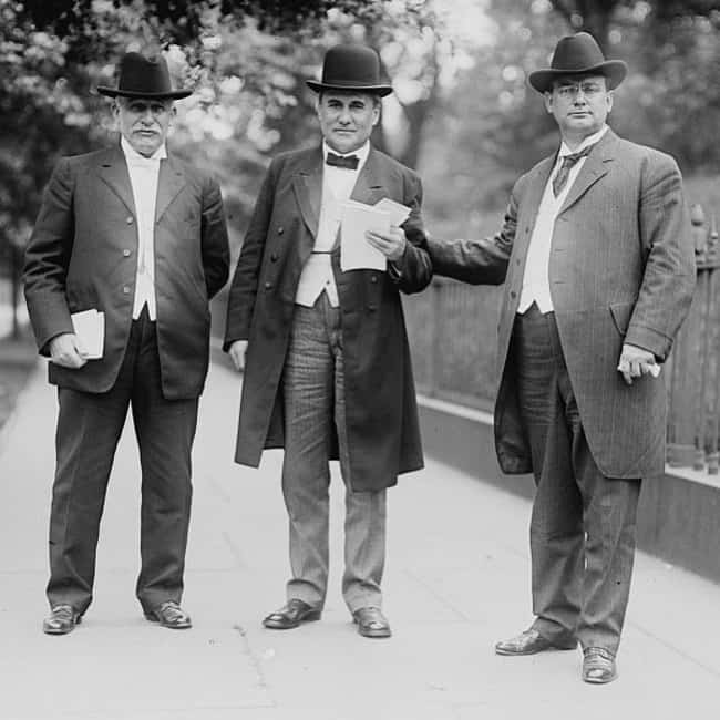 three men wearing suits in 1910