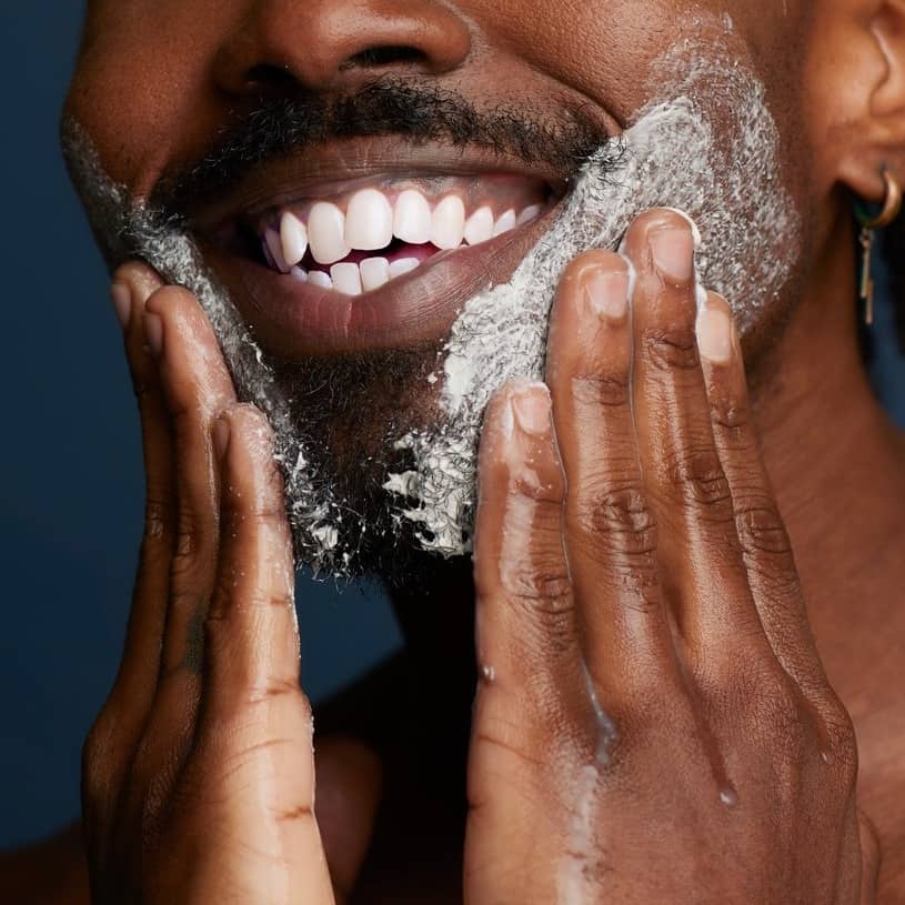 man applying jack black beard wash