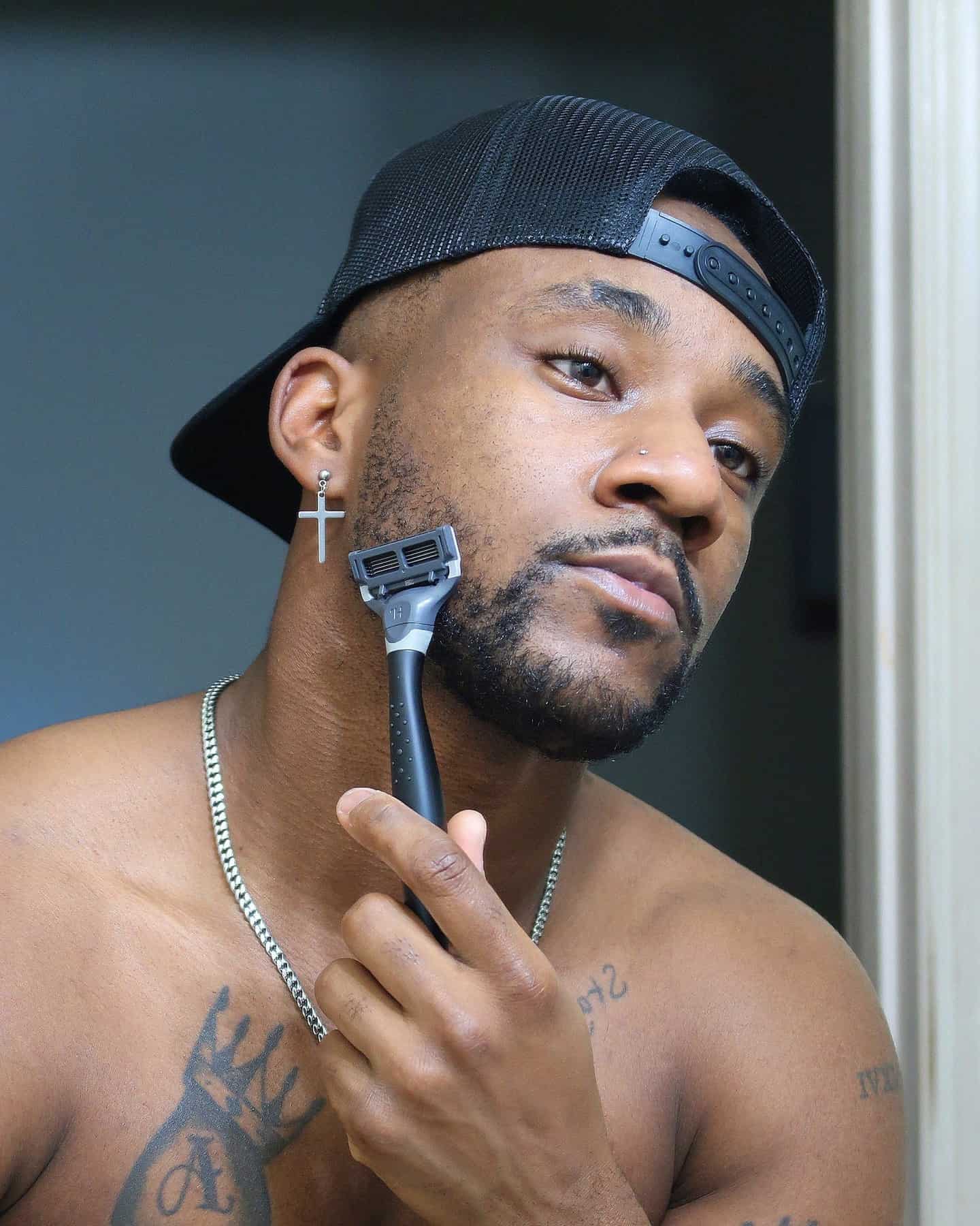 man shaving his beard