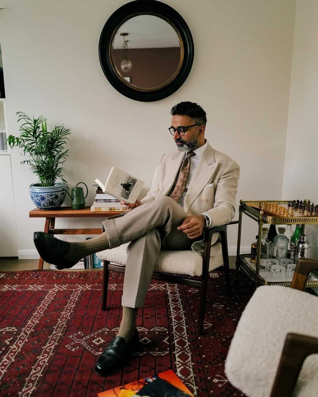 man in a suit reading a book