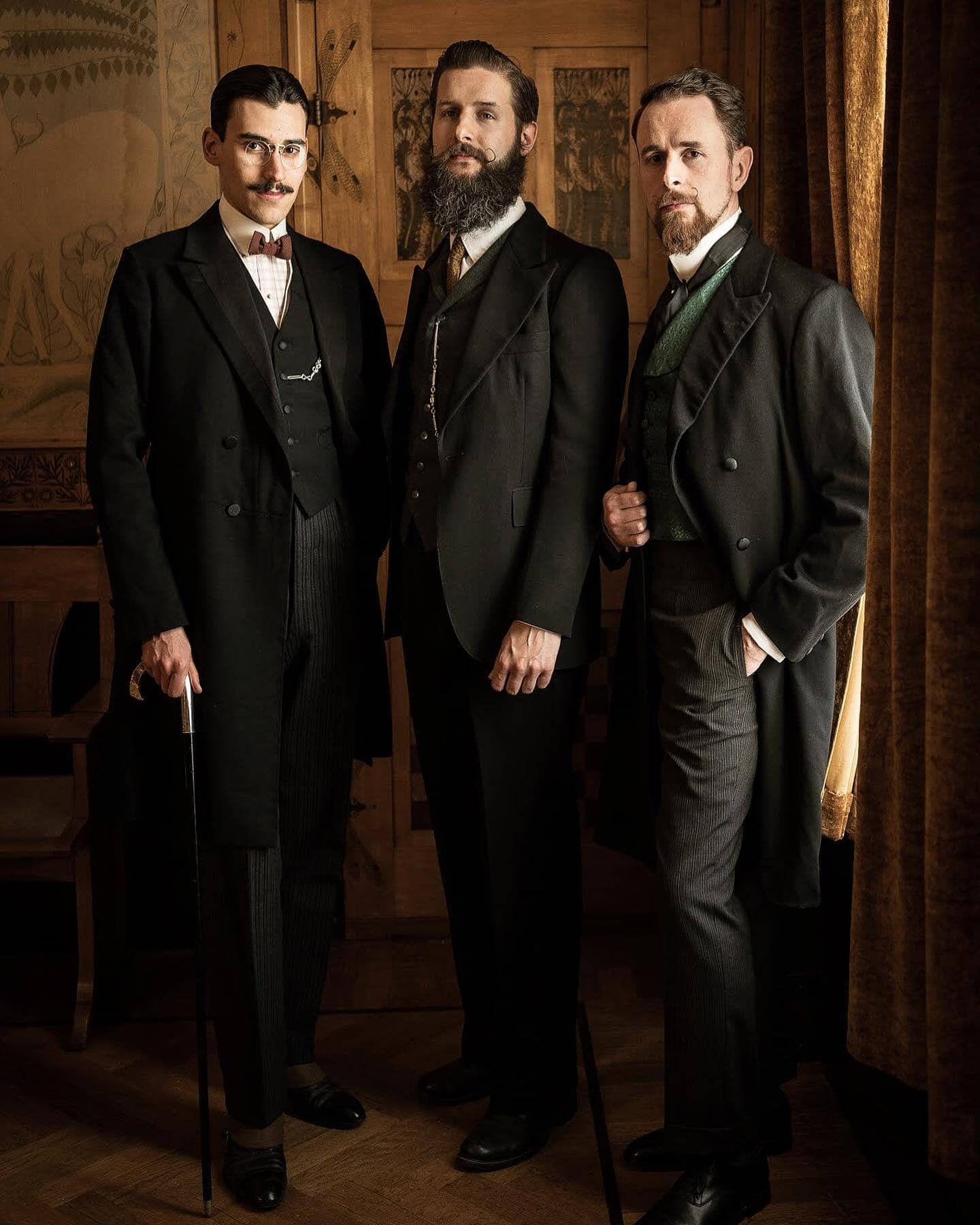 three men in a 1910 formalwear outfit