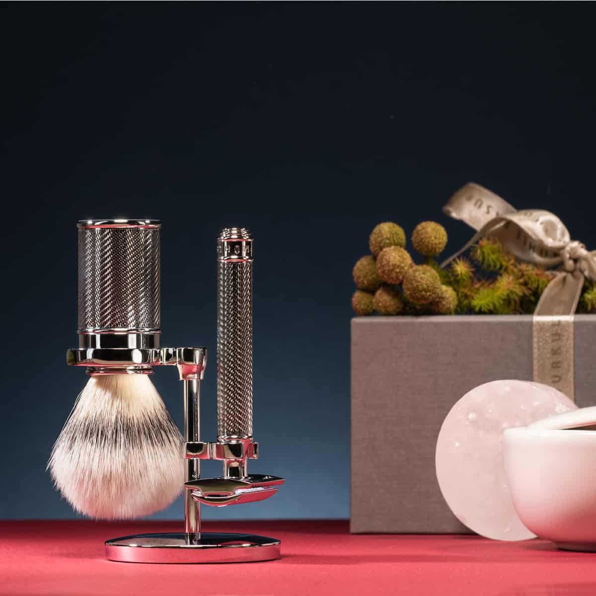a set of muehle shaving brush and safety razor on a stand by muehle