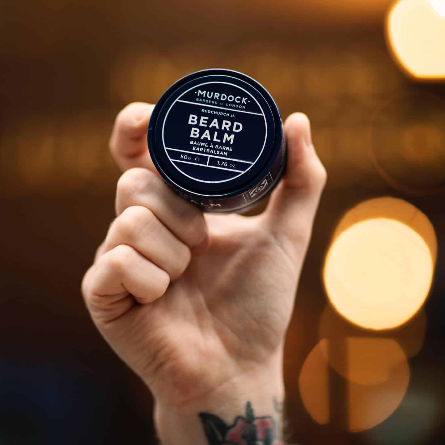 holding a can of beard balm by murdock