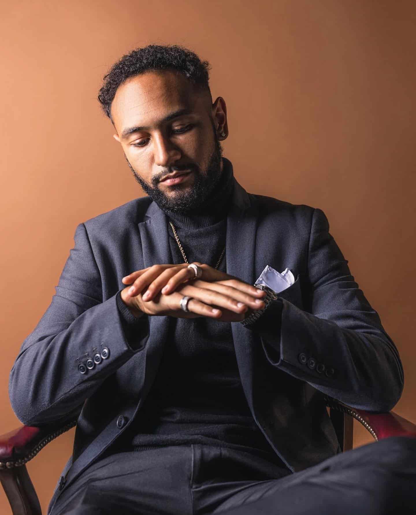 man in a suit sitting on a chair