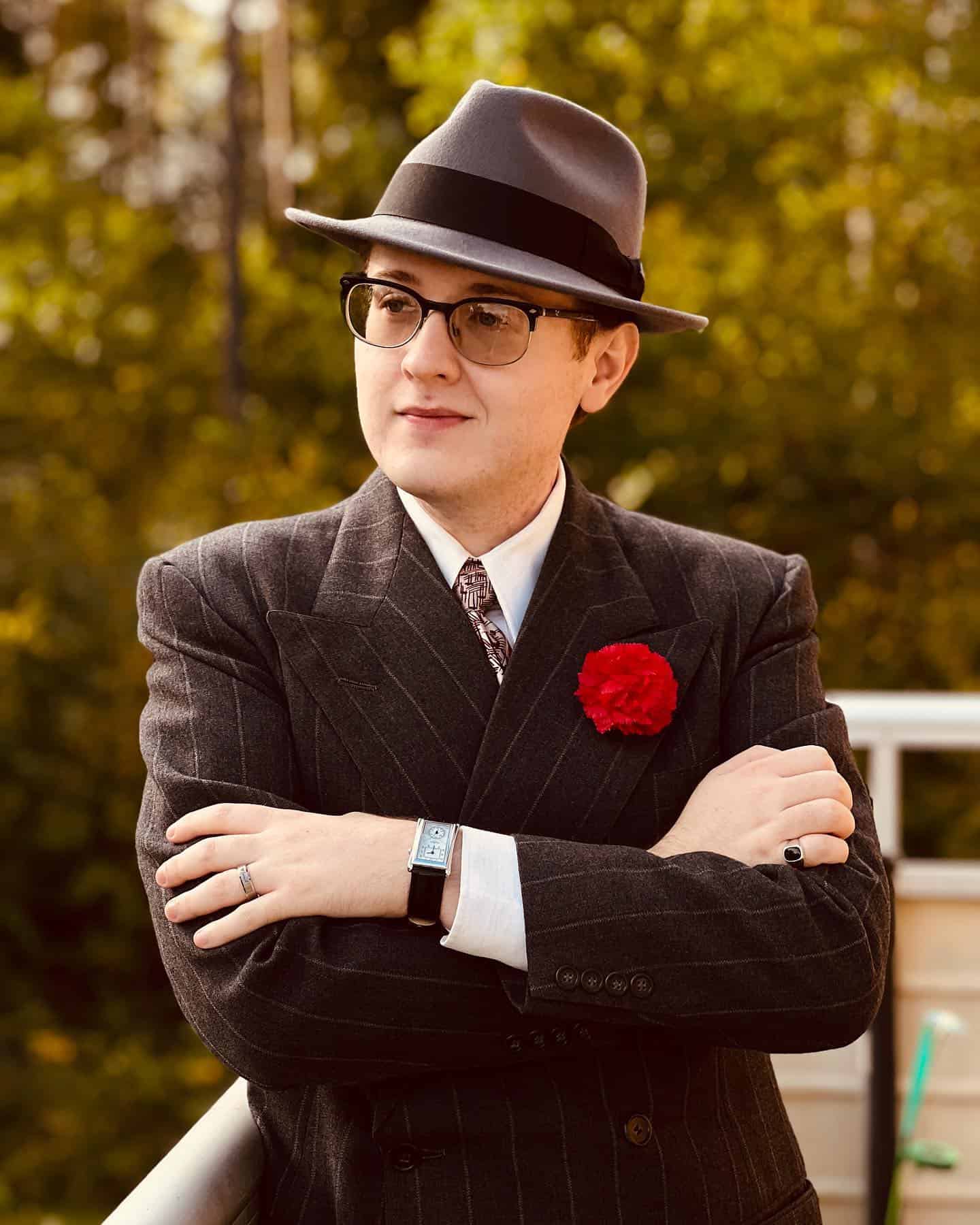 man wearing a vintage suit and a fedora hat