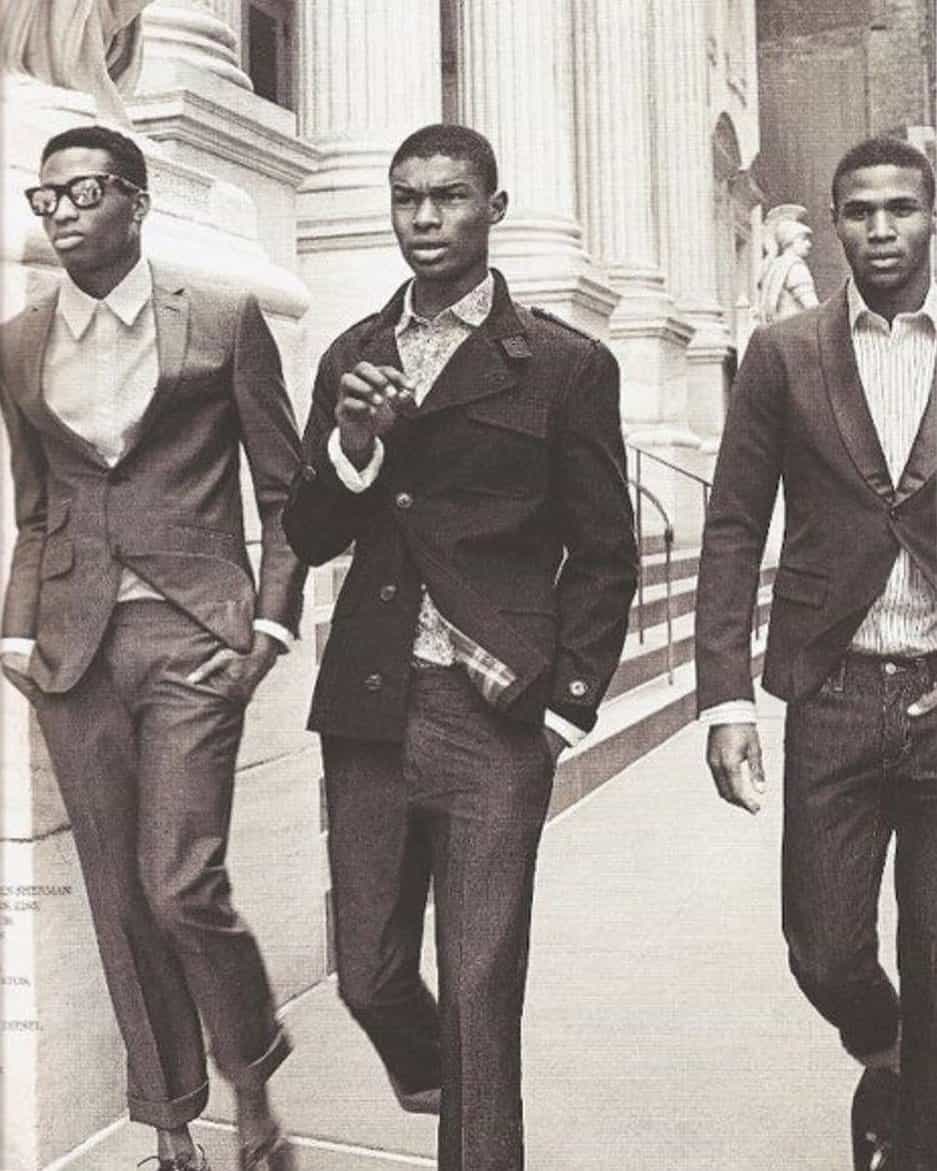 three men in 1960s wearing suits walking