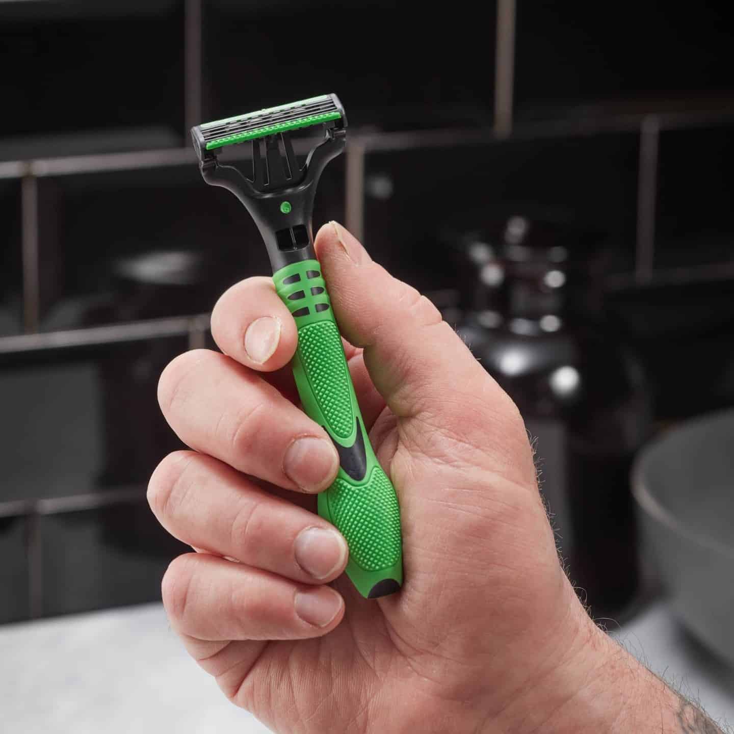 man holding a schick razor