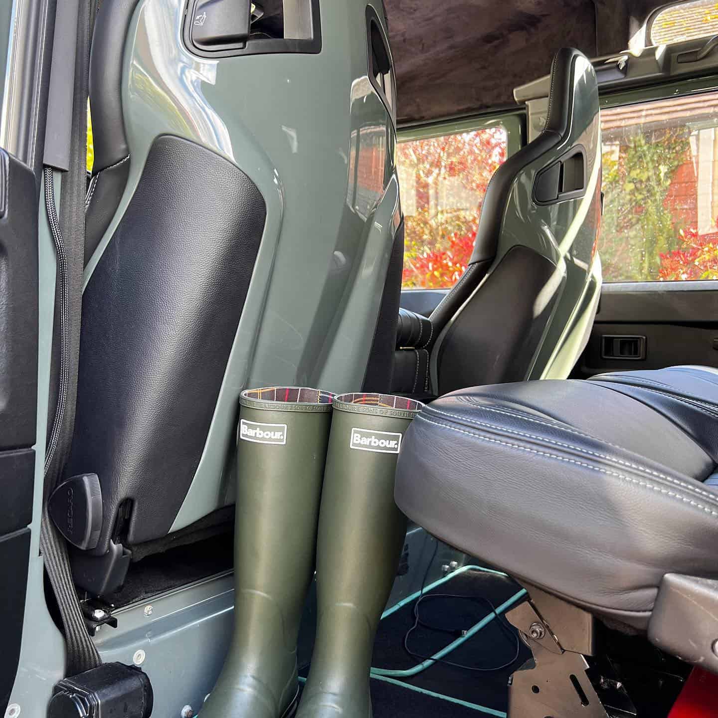 a pair of barbour rain boots in the car
