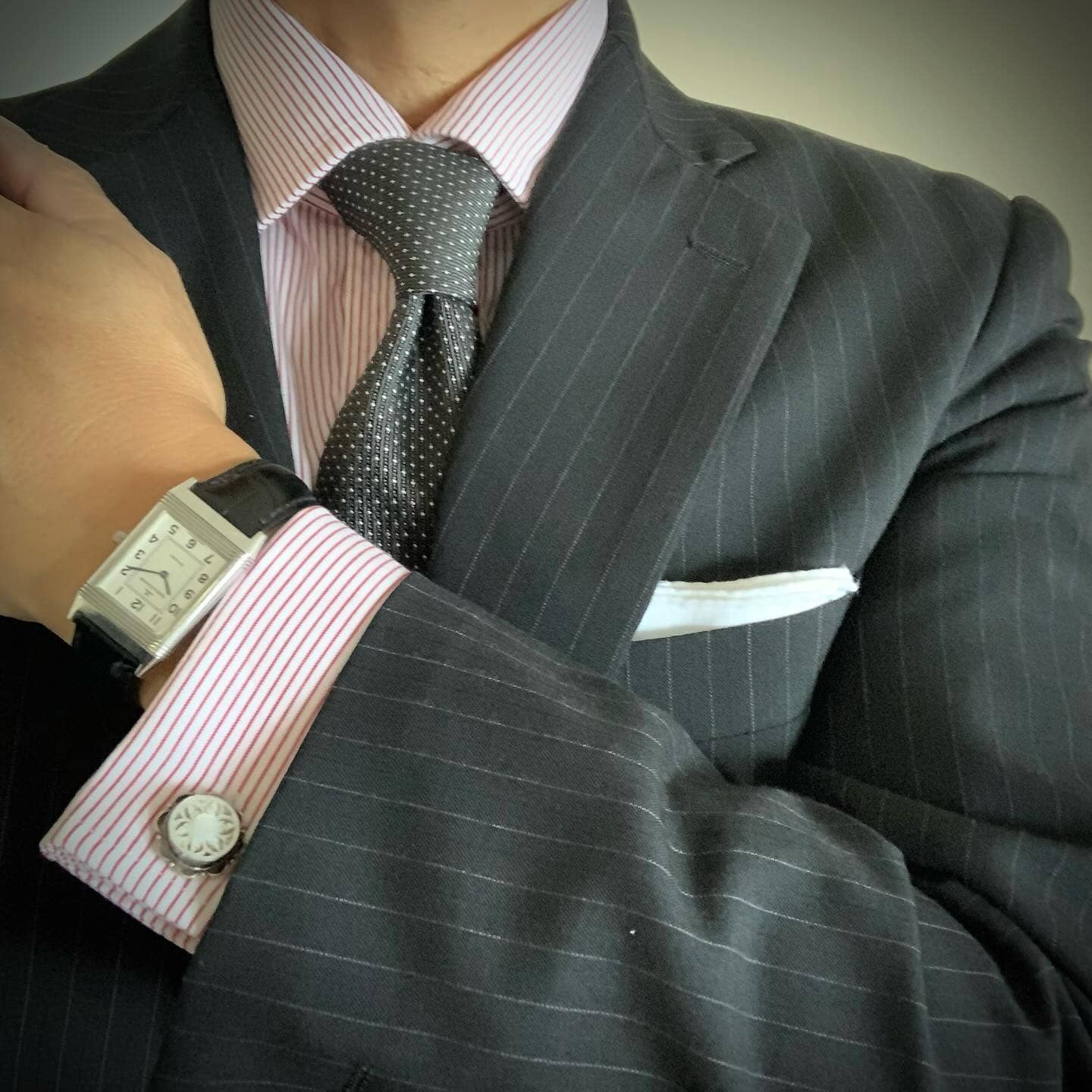 a white handkerchief in suit front pocket