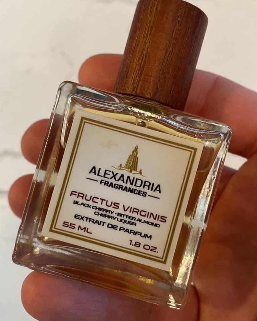 holding a bottle of fructus virginis parfum by alexandria fragrances
