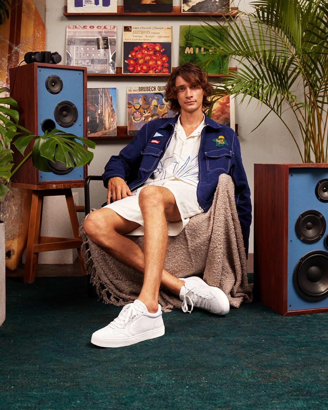 man with a denim jacket sitting on a chair