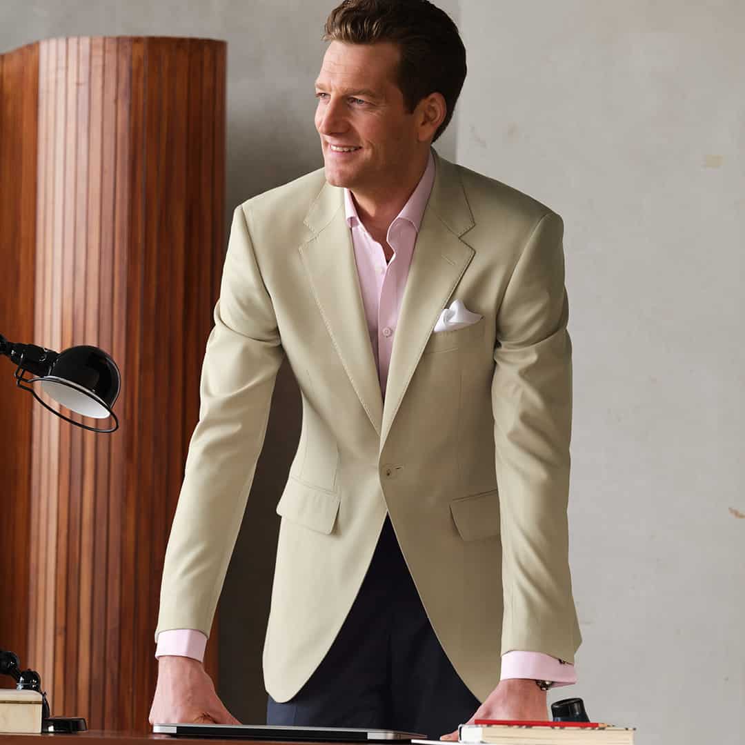 man in a pink shirt and light colored blazer