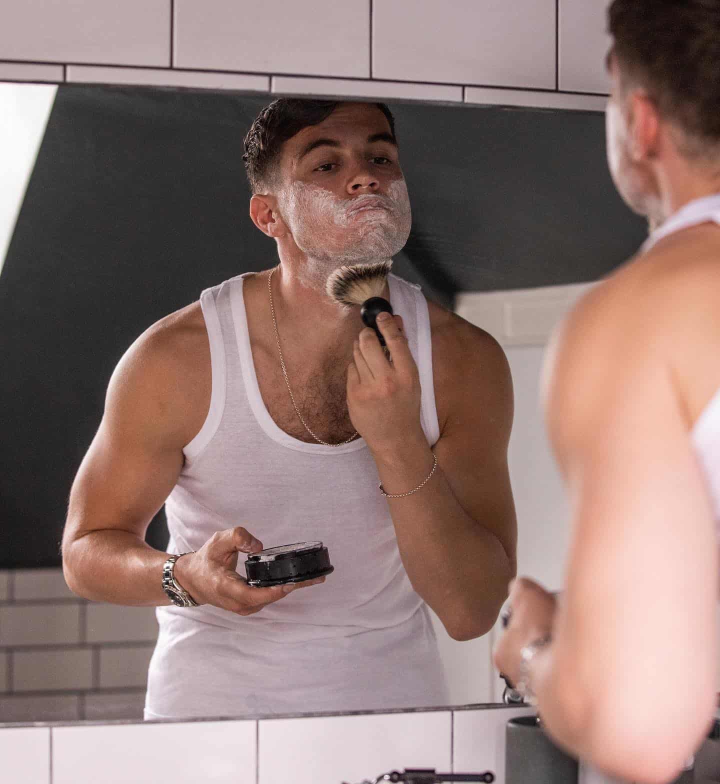 man applying shaving cream on face