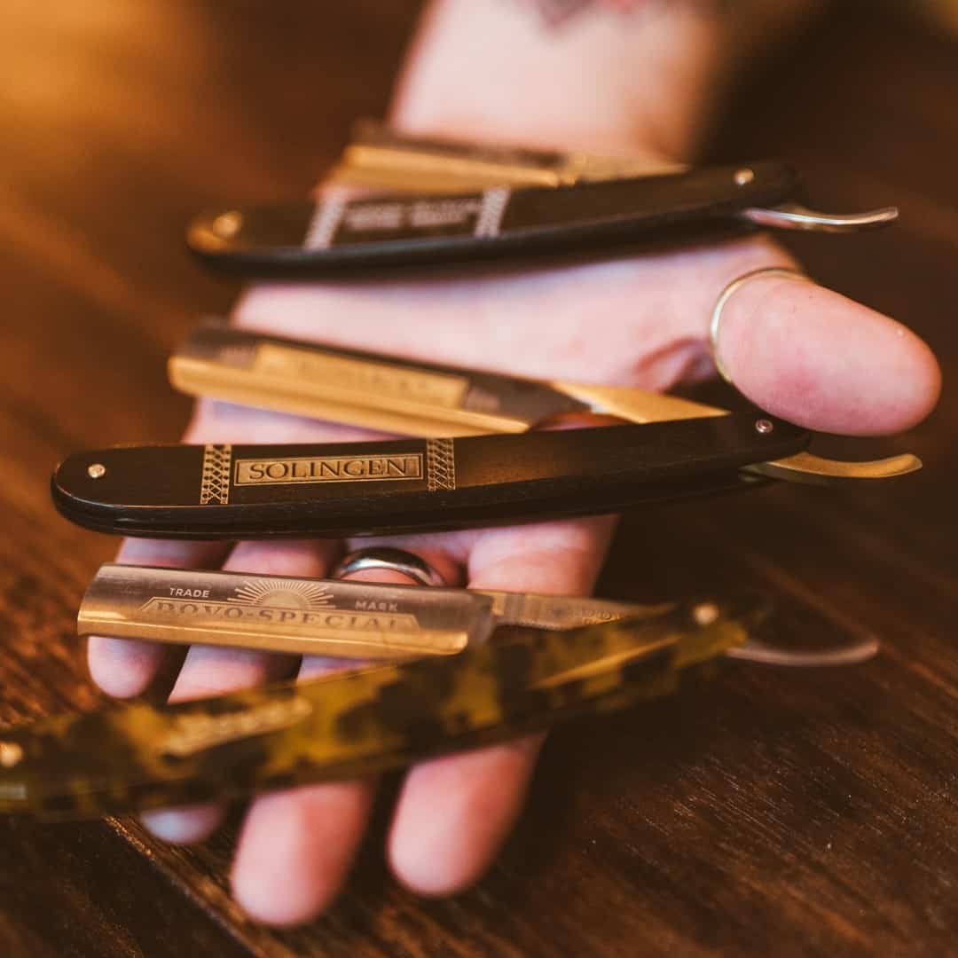 holding a collection of straight razors by dovo solingen