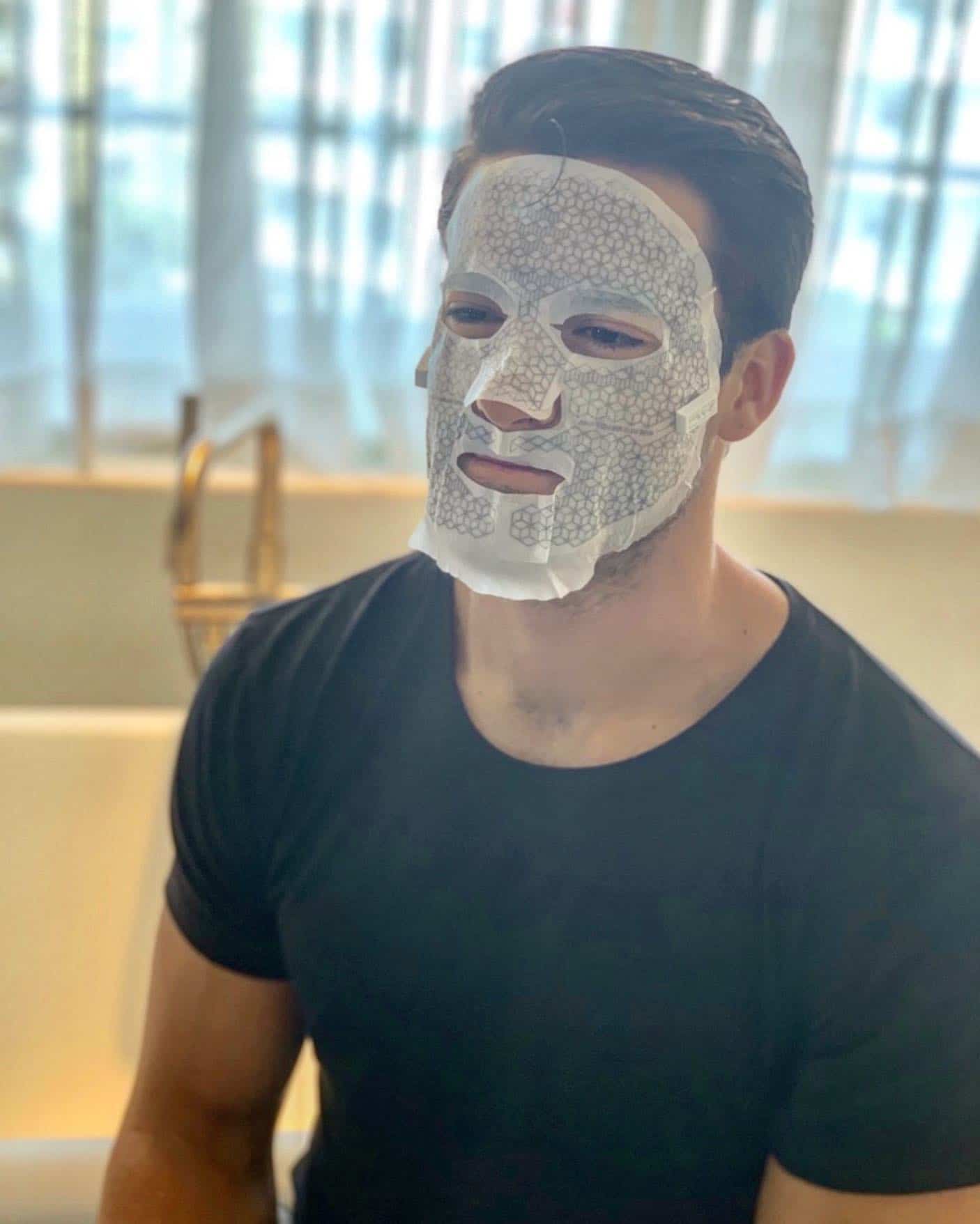 man with face mask sheet on