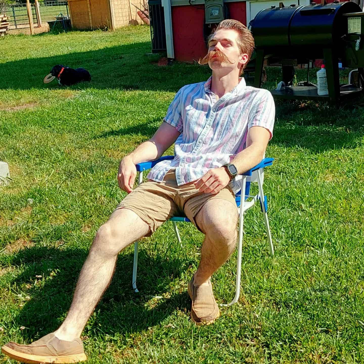 man with long mustache soaking under the sun