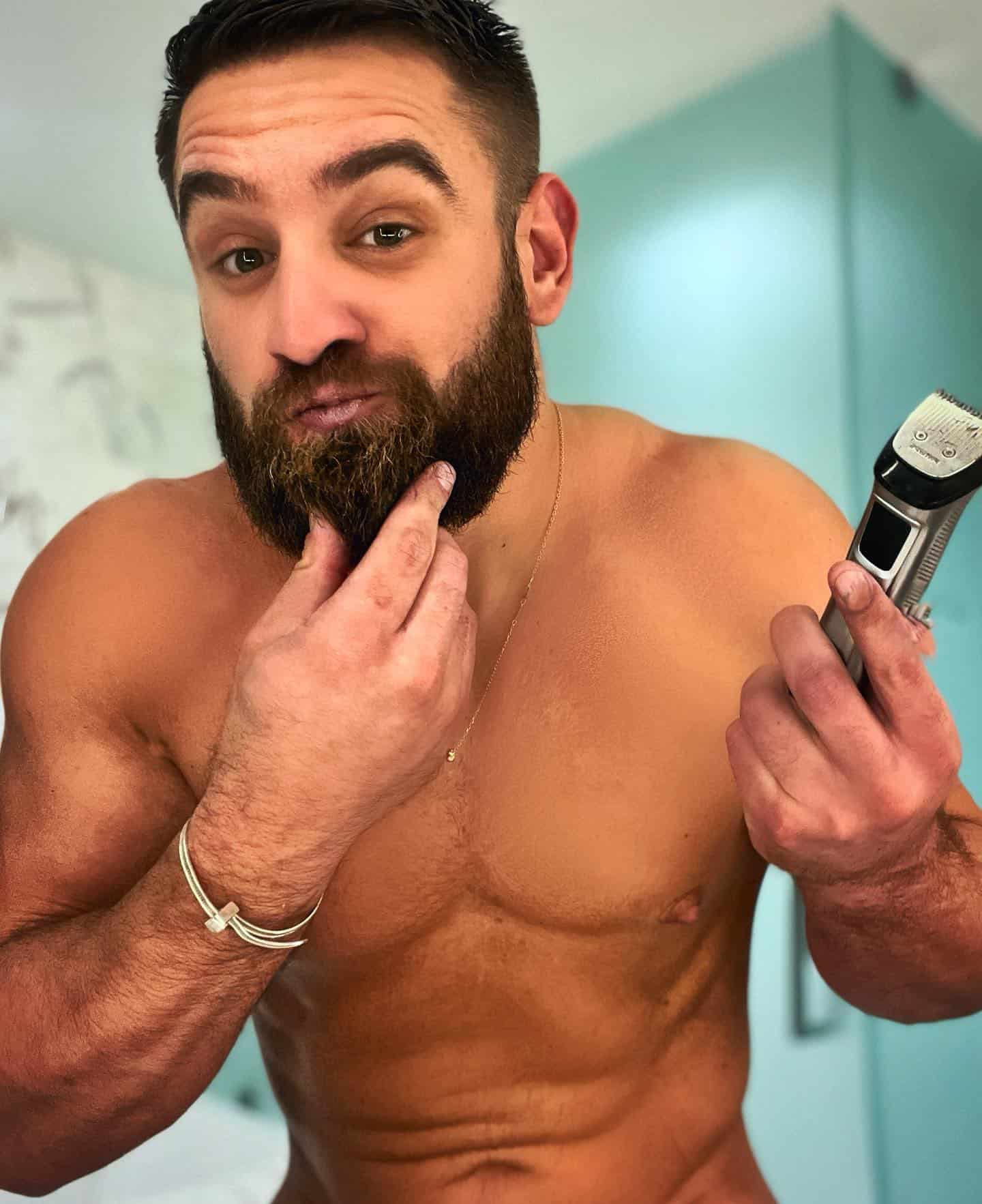 man holding a trimmer and checking his beard