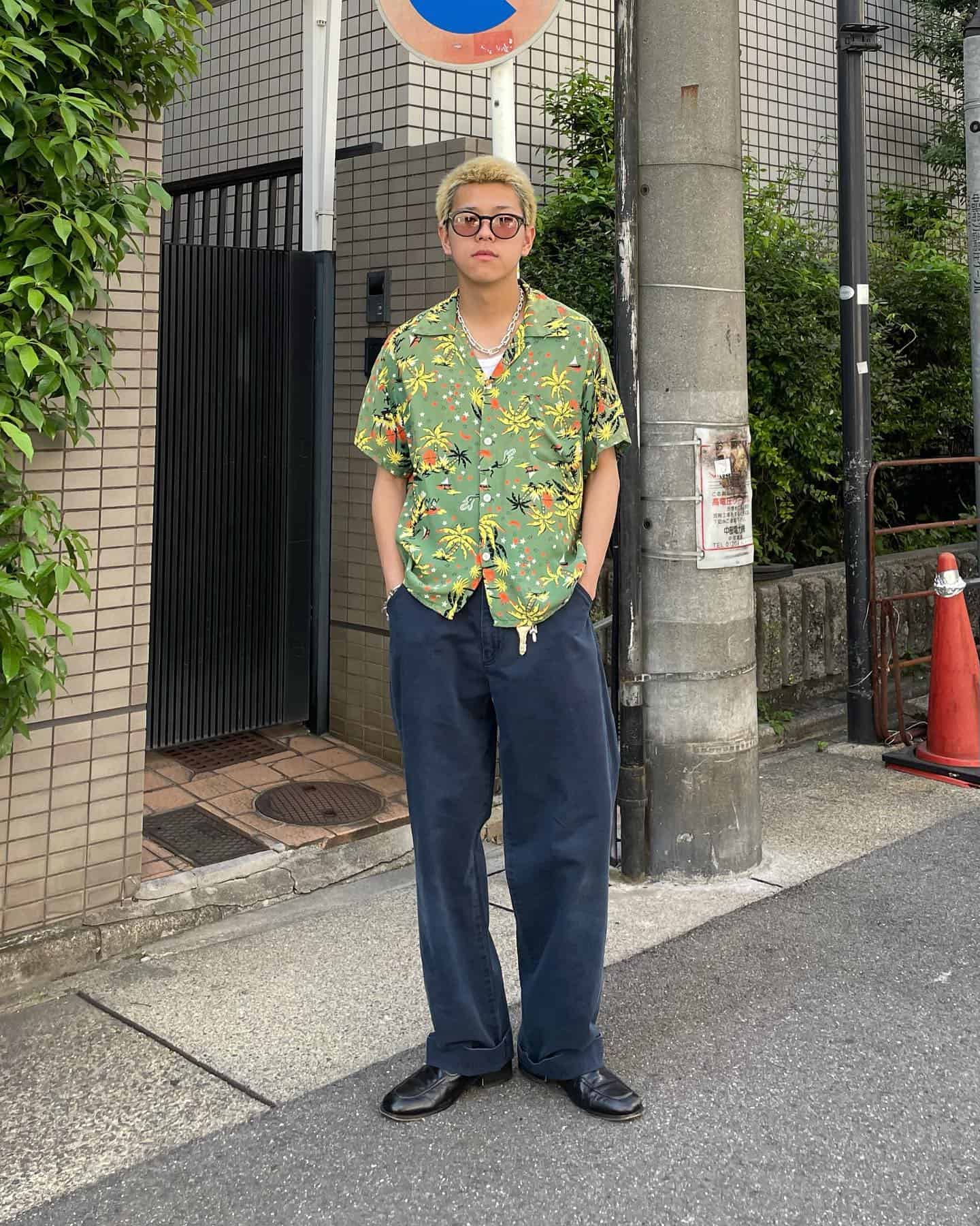man wearing a shirt with palm tree print