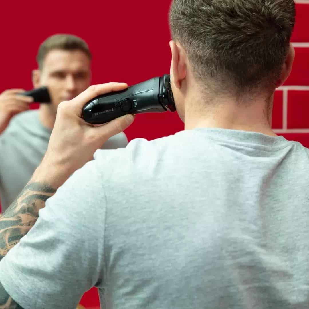 man using the r4 rotary shaver by remington