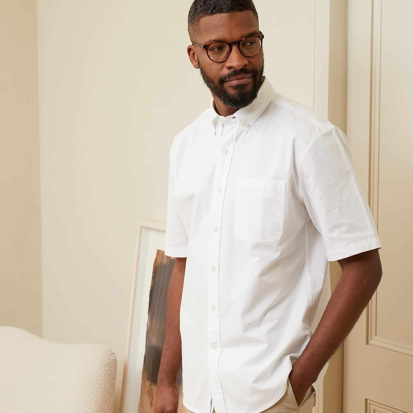 man with glasses wearing a white button down shirt