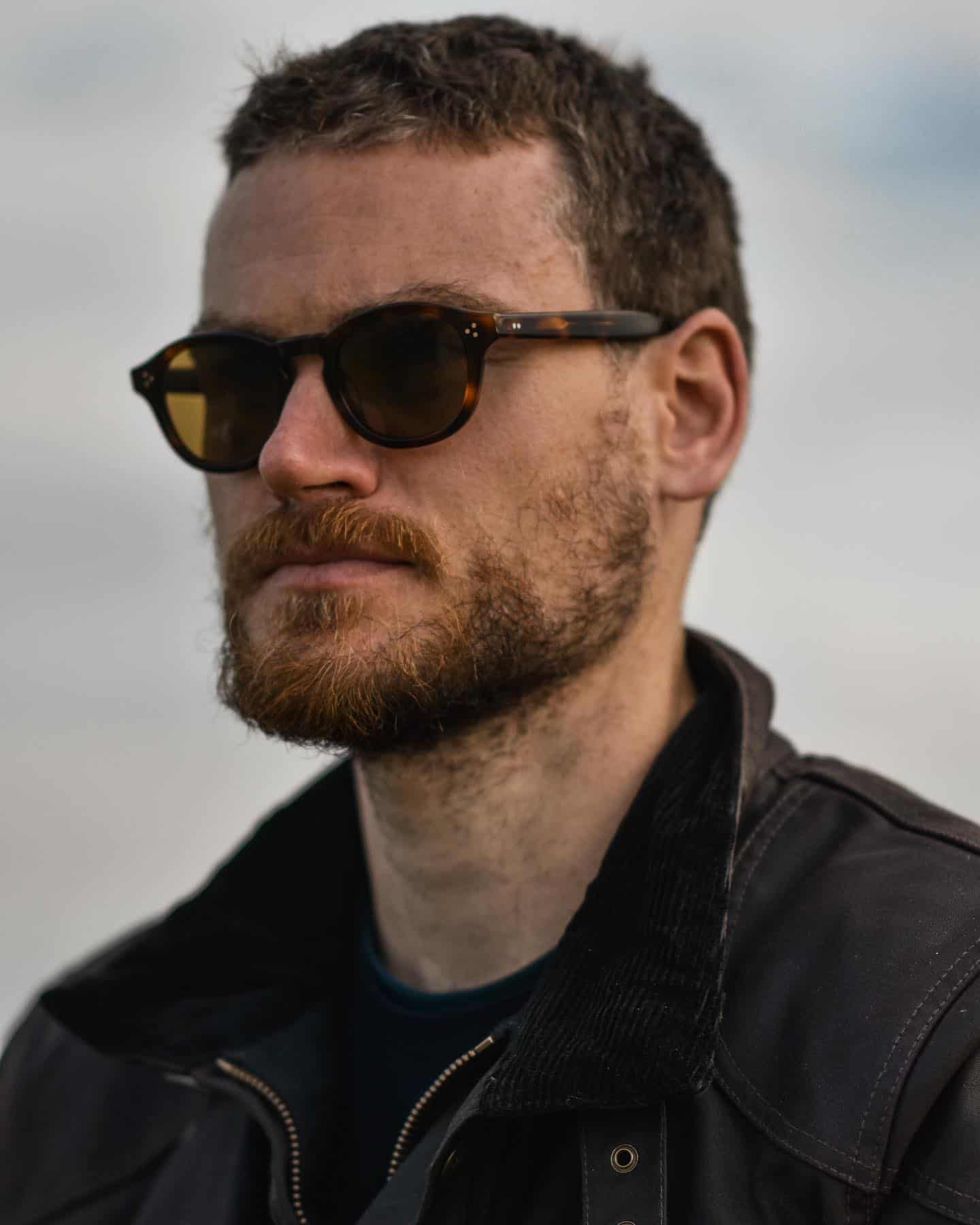 man in biker jacket wearing sunglasses