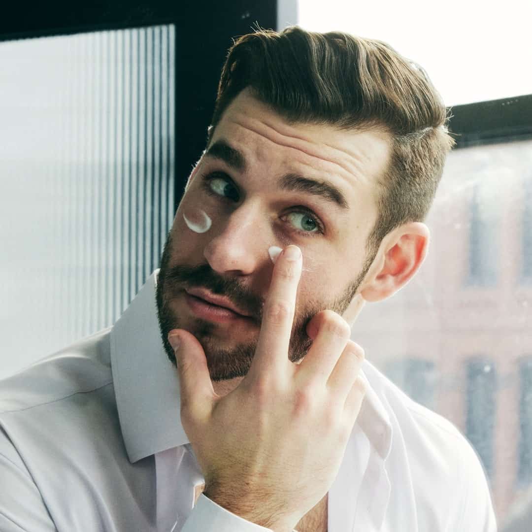 man applying an anti aging cream