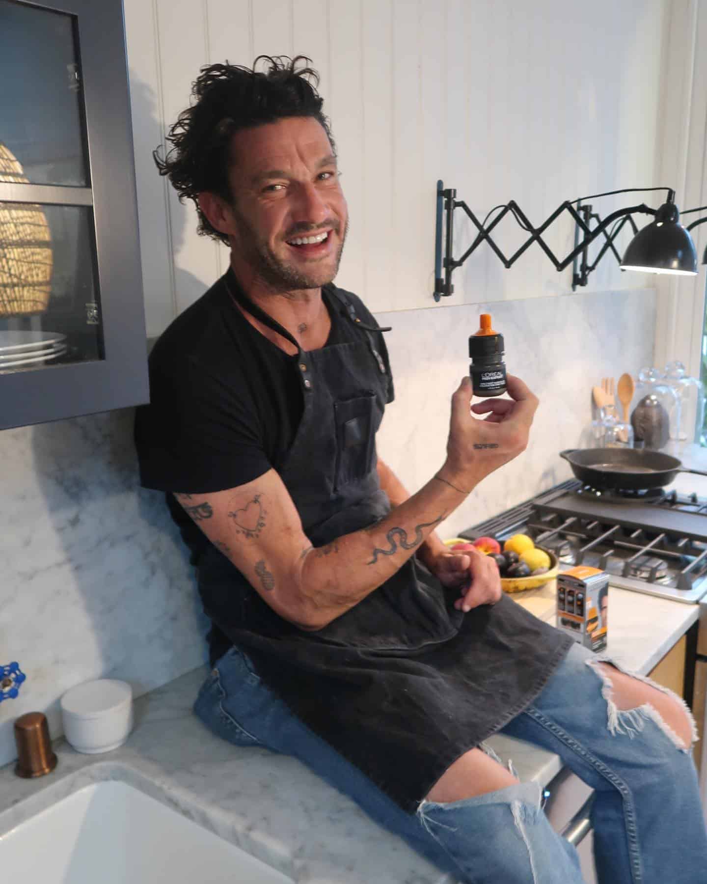 man holding a bottle of l'oreal one-twist hair color