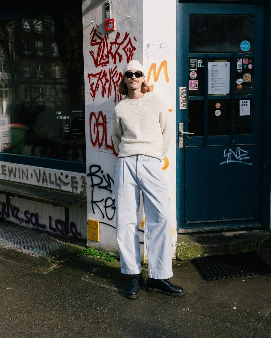 man in an off-white beanie and crew neck sweater